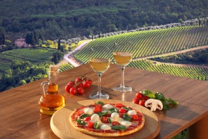 Italian pizza and glasses of white wine in Chianti, Italy